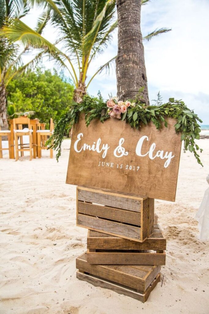 A Wooden Wedding Sign in a Beach Wedding