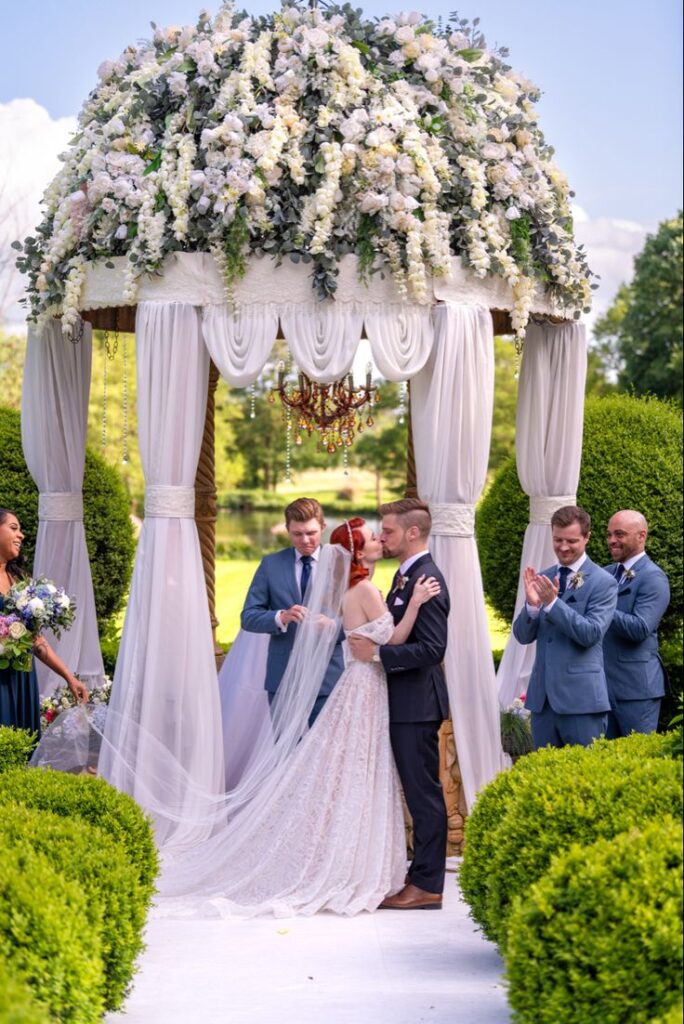 Bride and groom kissing at their wedding ceremony in The Loire Valley, France.