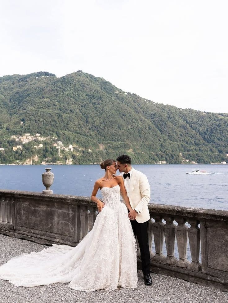 Bride and groom kissing by the riverside during their destination wedding