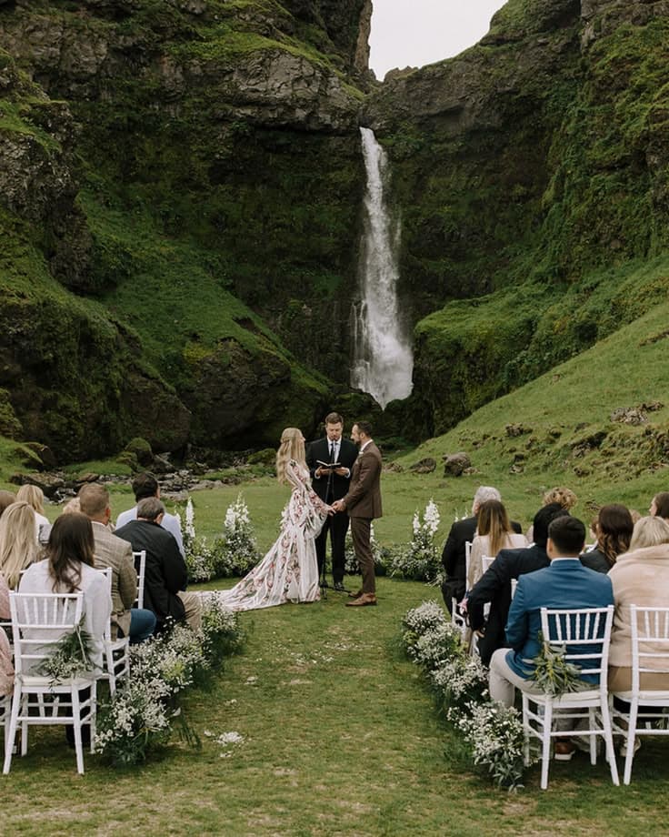 A dreamy  wedding in iceland with green mountains and waterfall as the backdrop.