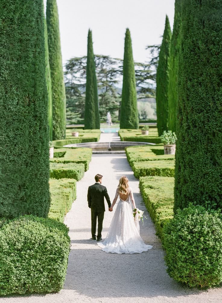 Couple walking down Château de Sannes, a 17th-century estate located in the Luberon region of Provence, France.