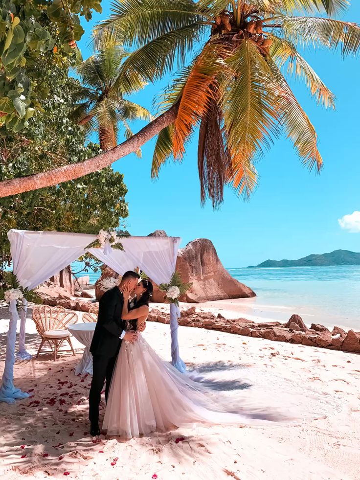 Couple kissing at one of the most beautiful beach destinations - Seychelles