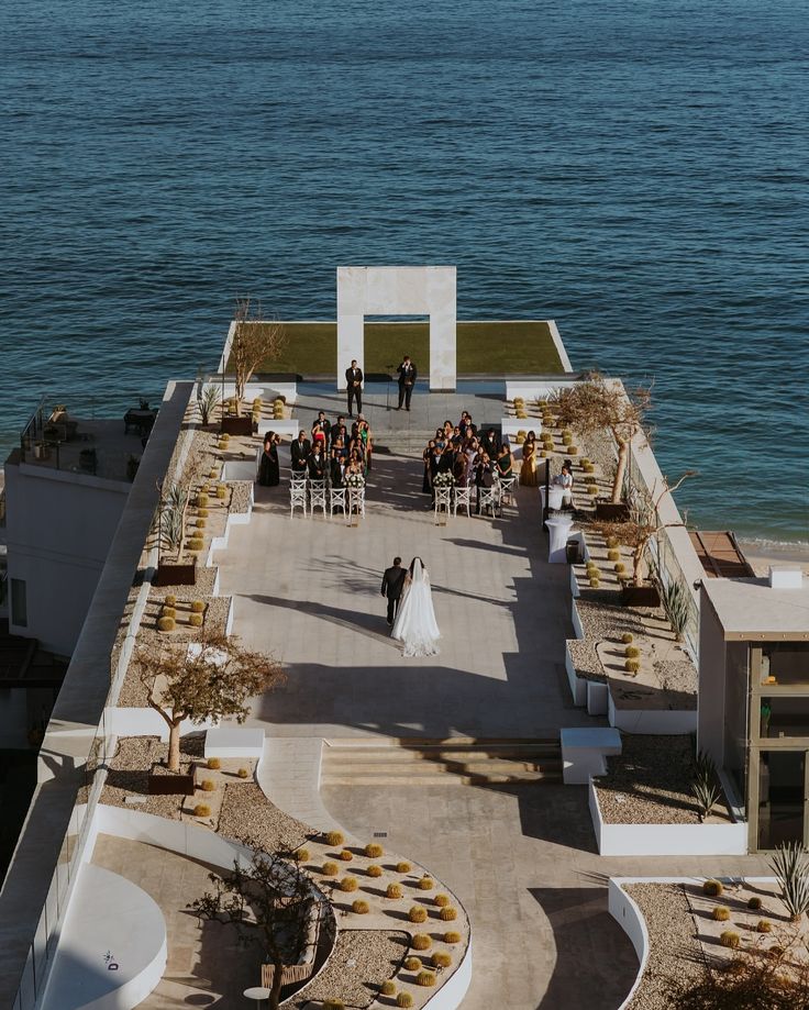 Couple walking down the aisle at a luxurious beach wedding in Cabo San Lucas, Mexico 